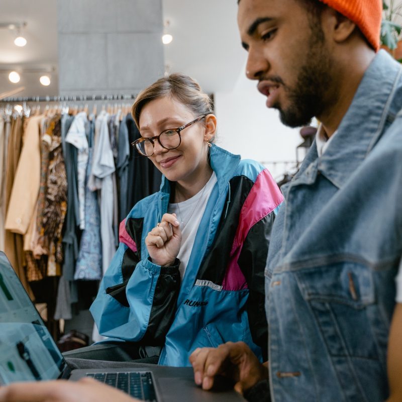 man and woman holding laptop